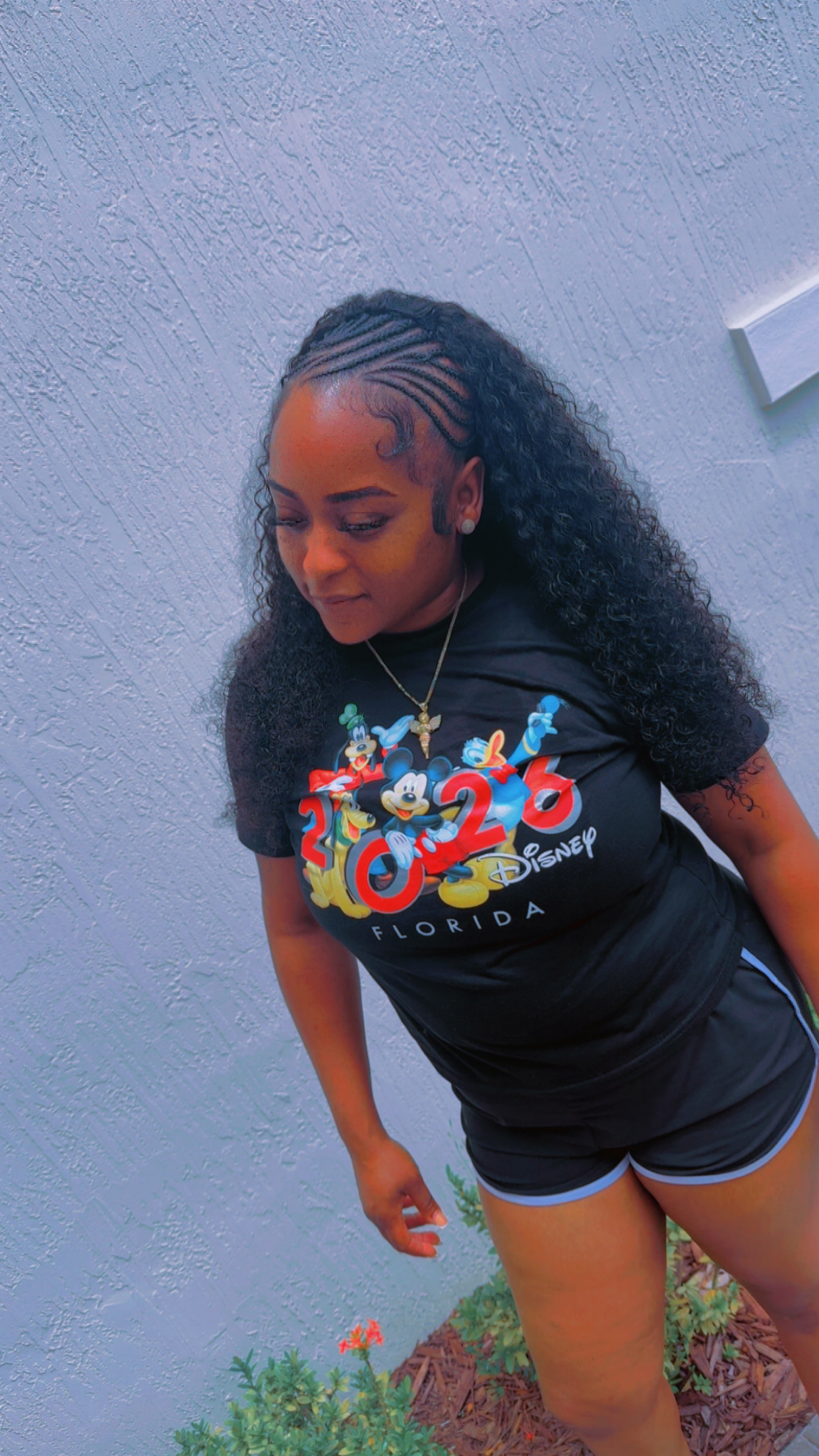 Curly half-up protective style with detailed side cornrows